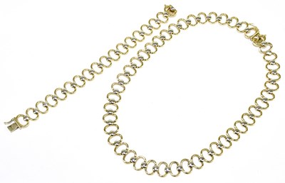 Lot 227 - A 9ct yellow and white gold open hoop link...