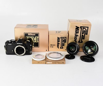 Lot 471 - NIKON; a camera outfit comprising a boxed FM2...