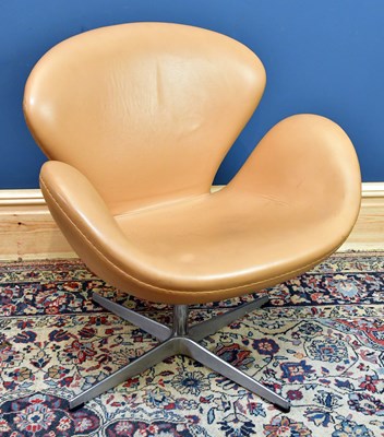 Lot 2534 - AFTER ARNE JACOBSEN; a leather swan chair,...