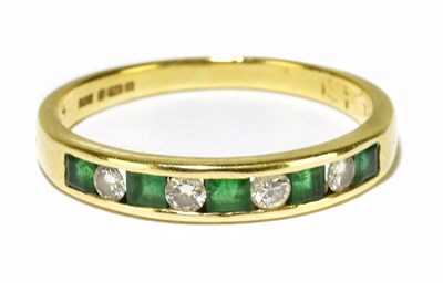 Lot 118 - An 18ct yellow gold emerald and diamond half...