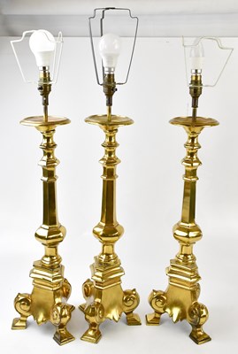 Lot 2346 - A set of three contemporary brass table lamps,...