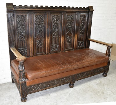 Lot 2511 - A large late 19th century carved oak settle...