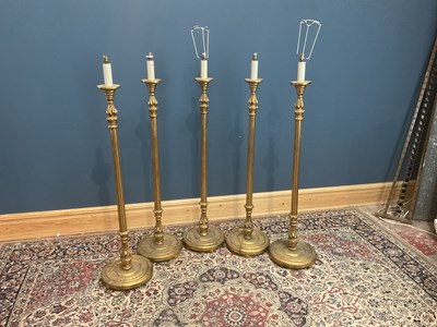 Lot 2335 - A harlequin set of five gilt standard lamps,...