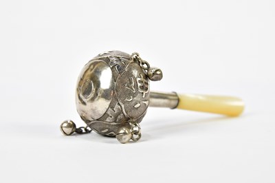 Lot 1089 - A Chinese white metal rattle with four bells...