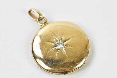 Lot 470 - A yellow metal diamond set locket of circular...