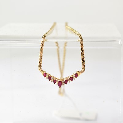 Lot 889 - A yellow metal necklace set with marquise cut...