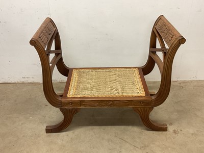 Lot 635 - An Egyptian style sledge end seat with rush...