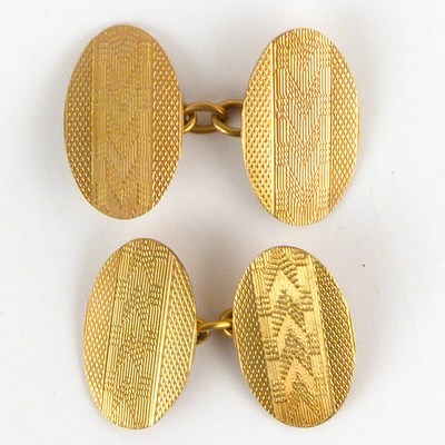 Lot 904 - A pair of 9ct gold oval cufflinks with engine...