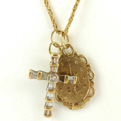 Lot 877 - A 9ct gold small oval religious pendant with...