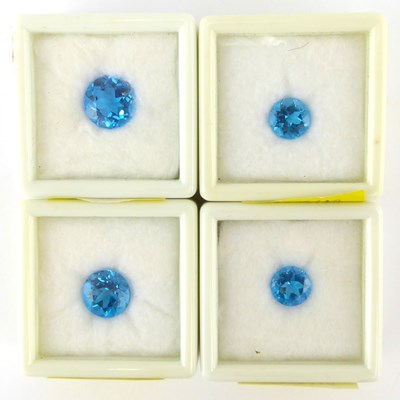 Lot 940 - Four loose and boxed blue topaz stones, 7ct,...