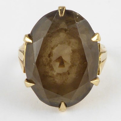 Lot 820 - A 9ct gold claw set oval smoky quartz in...