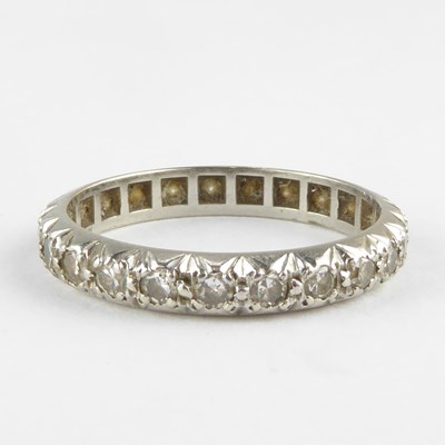 Lot 835 - An eternity ring set with tiny diamonds in...