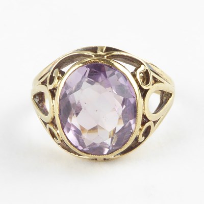 Lot 819 - A 9ct gold amethyst dress ring with scroll...