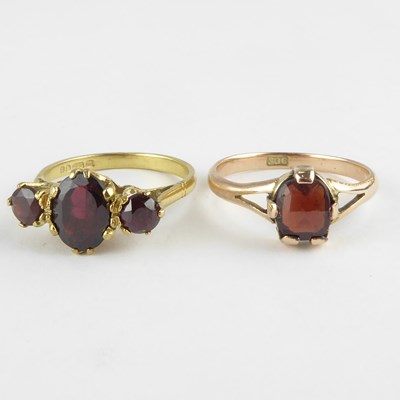 Lot 810 - Two 9ct gold garnet dress rings, comprising a...