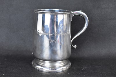 Lot 576 - A George V hallmarked silver mug, inscribed...