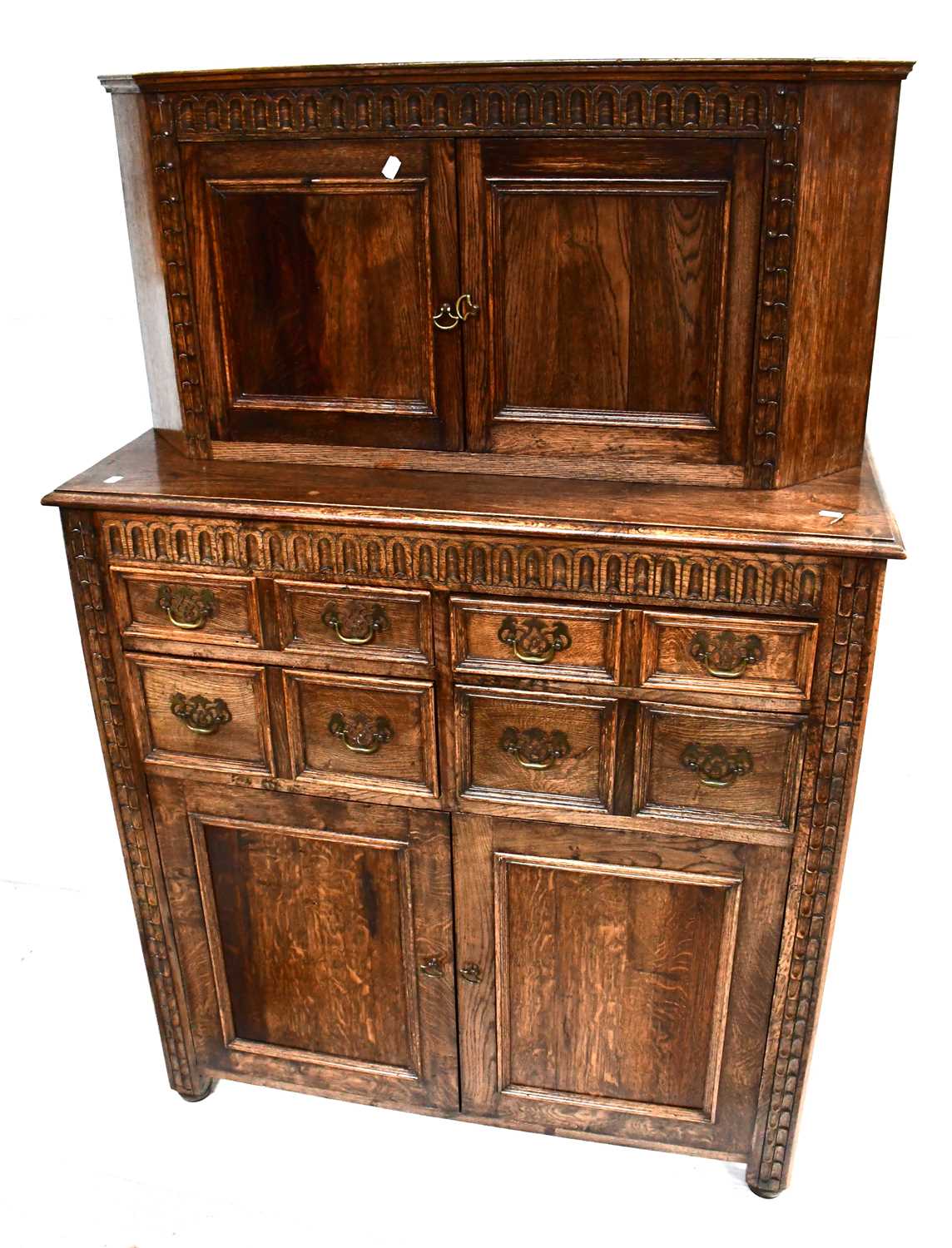 Lot 32 - A reproduction carved oak court cupboard, the...