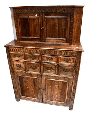 Lot 32 - A reproduction carved oak court cupboard, the...