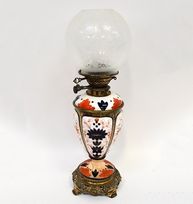 Lot 120 - A Victorian ceramic oil lamp decorated in the...