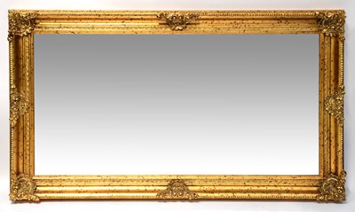 Lot 101 - A large ornate giltwood framed bevel-edged...