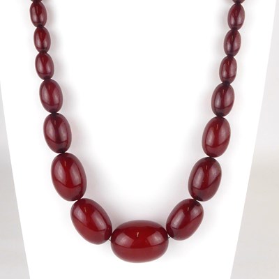 Lot 893 - A string of graduated carnelian amber-style...