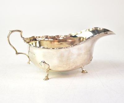 Lot 573 - A George V hallmarked silver sauce boat with...