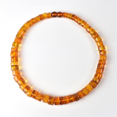 Lot 892 - An amber necklace of graduated cylindrical...