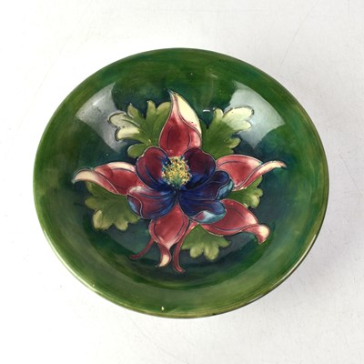 Lot 263 - MOORCROFT; an Anemone pattern bowl on green...