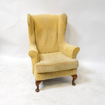 Lot 53 - A 1930s oak framed wing back armchair...