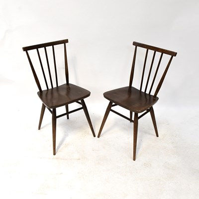 Lot 17 - ERCOL; four dark stained stick back dining...