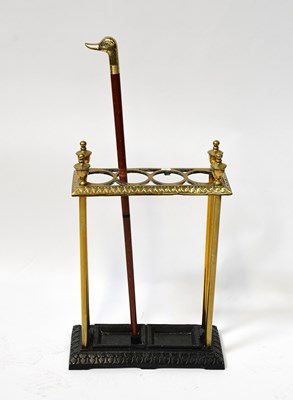 Lot 33 - A brass umbrella and stick stand with four...