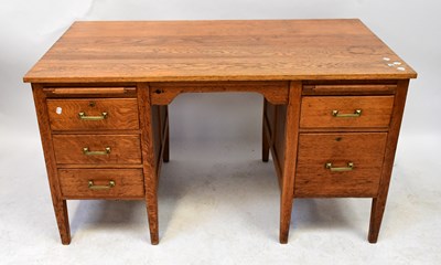 Lot 22 - A mid-20th century oak desk comprising two...