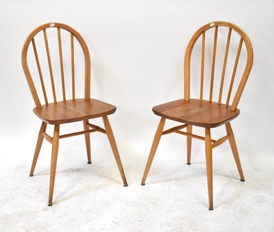 Lot 18 - ERCOL; four light elm stick back dining chairs...