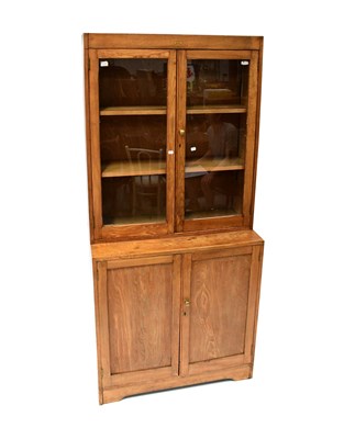 Lot 45 - An early 20th century oak glazed bookcase with...