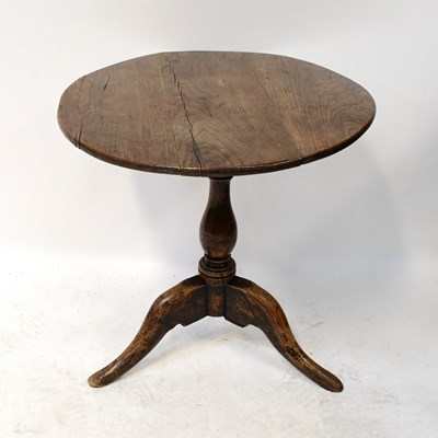 Lot 79 - A 19th century oak circular tilt-top table on...