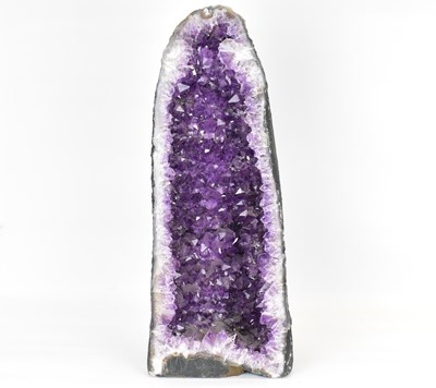 Lot 157 - A large amethyst and quartz 'cathedral' geode,...