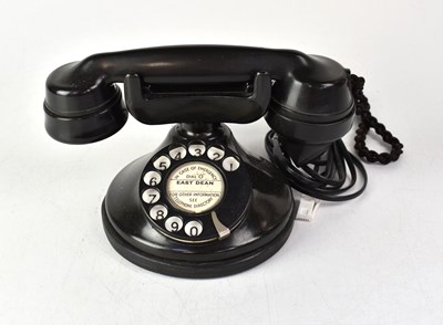 Lot 149 - A black telephone with dial, the centre...