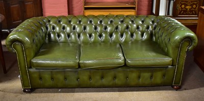 Lot 3039 - A green leather Chesterfield three seater sofa...