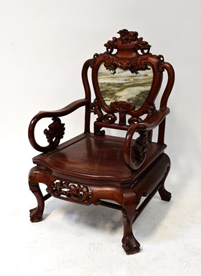 Lot 49 - A Chinese carved hardwood open armchair, the...