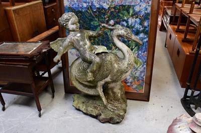 Lot 110 - A composite garden statue of a cherub riding a...