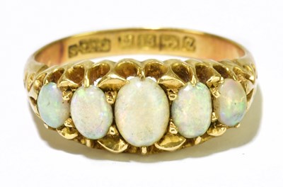 Lot 48 - An 18ct yellow gold five stone opal oval ring,...