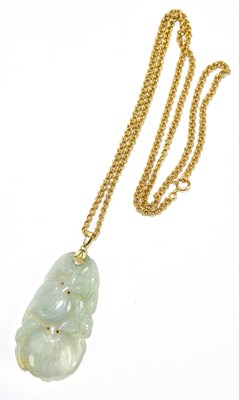 Lot 224 - A Chinese russet included jade pendant...