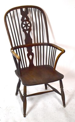 Lot 1505 - A 19th century elm seated Windsor elbow chair,...