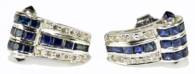 Lot 319 - A pair of white metal sapphire and diamond...