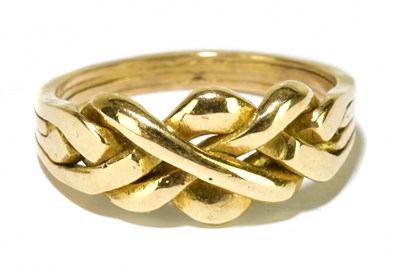 Lot 145 - A yellow metal puzzle ring formed of four...