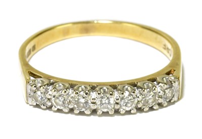 Lot 77 - An 18ct yellow gold seven stone diamond half...