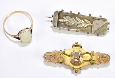 Lot 304 - A Victorian 9ct yellow gold bar brooch centred...