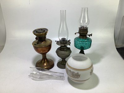 Lot 2349 - A group of three oil lamps to include a brass...