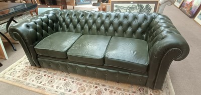 Lot 2572 - A green leather three seater Chesterfield sofa,...