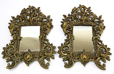 Lot 28 - A pair of decorative gilt brass wall mirrors,...