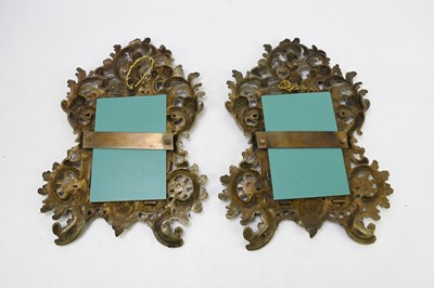 Lot 28 - A pair of decorative gilt brass wall mirrors,...